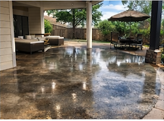 Beautiful stained concrete patio with outdoor furniture in Austin, Texas backyard